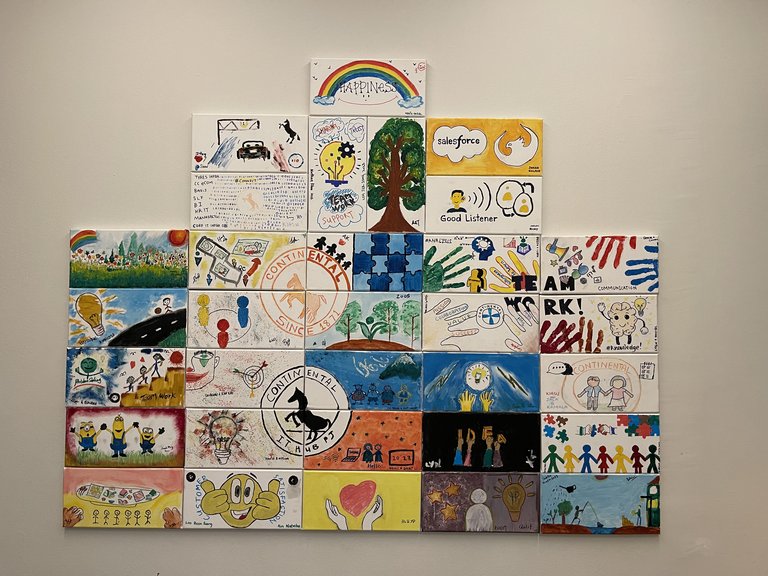 Diffrent paintings on a wall become one big work of art