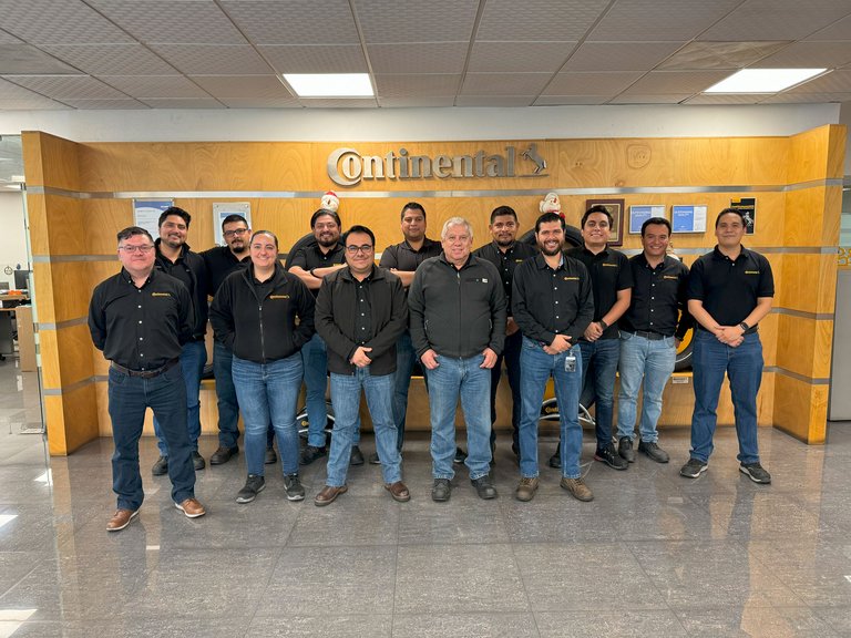 People standing in front of Continental logo