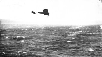 Airplane flys over water