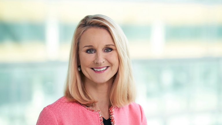 Portrait of a blonde woman in a pink jacket
